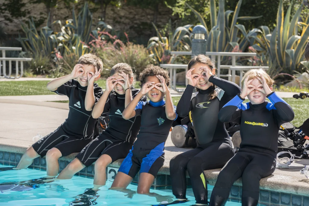A child on a first scuba dive in Eilat with a PADI instructor