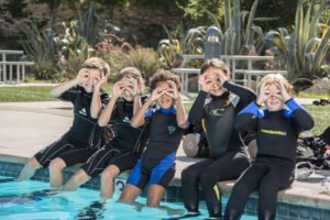 A child on a first scuba dive in Eilat with a PADI instructor